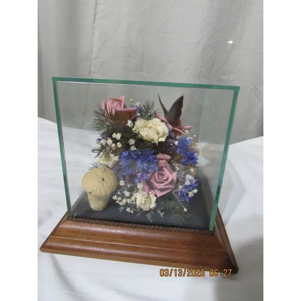 Vintage dried flower arrangement in glass with wood base butterfly mushrooms